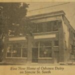 Two storey brick building with large windows. Text below the image reads: Fine New Home of Oshawa Dairy on Simcoe St. South