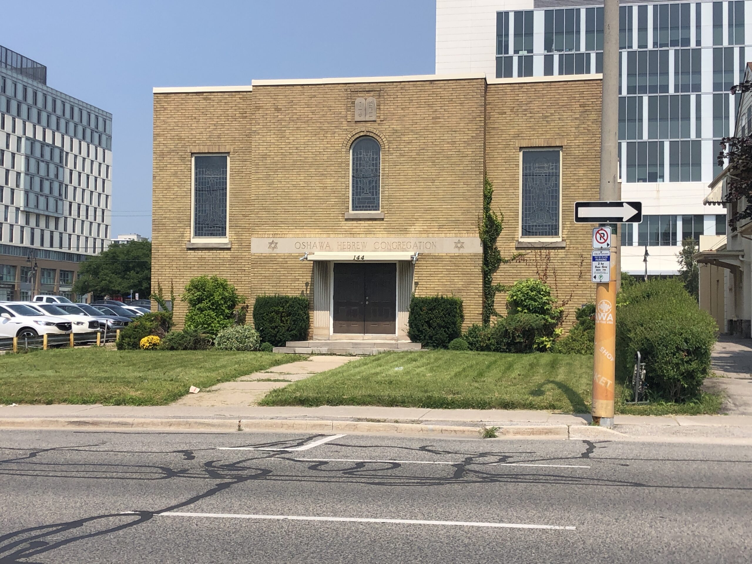 Large brick building, three stained glass windows, and the words 'Oshawa Hebrew Congregation' carved above the door