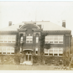 Black and white image, Oshawa CVI in 1930; a two storey, ivy covered, brick building