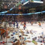 Various skaters on the ice in the arena empty bags of Teddy Bears
