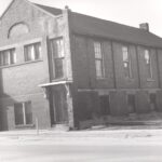 Black and white photo of a two storey brick building