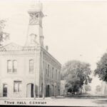 Black and white photograph of a rectangular building with a tower shaped structure placed on top. The writing at the bottom reads "Town Hall Oshawa"